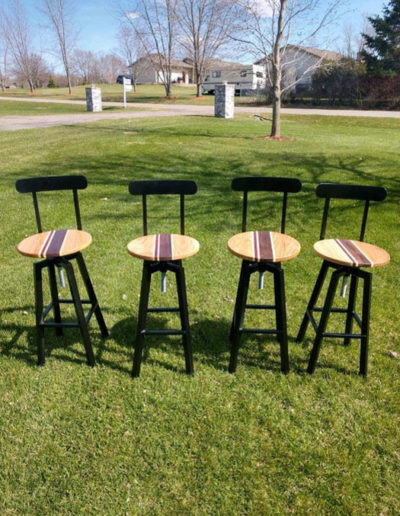 four custom wood bar stools on the lawn to display